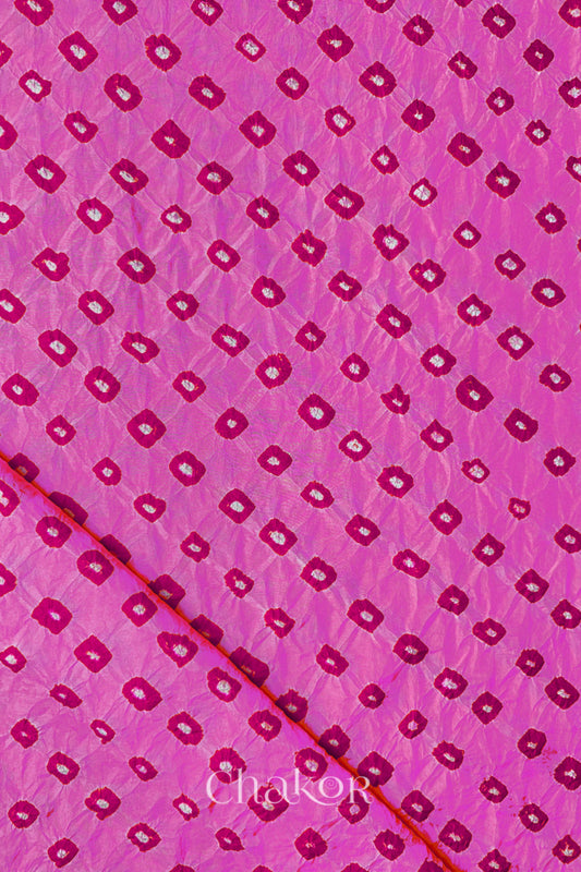 Light Pink Mulberry silk fabric showcasing dual colour Pink bandhani patterns with folded corner and Chakor brand watermark.
