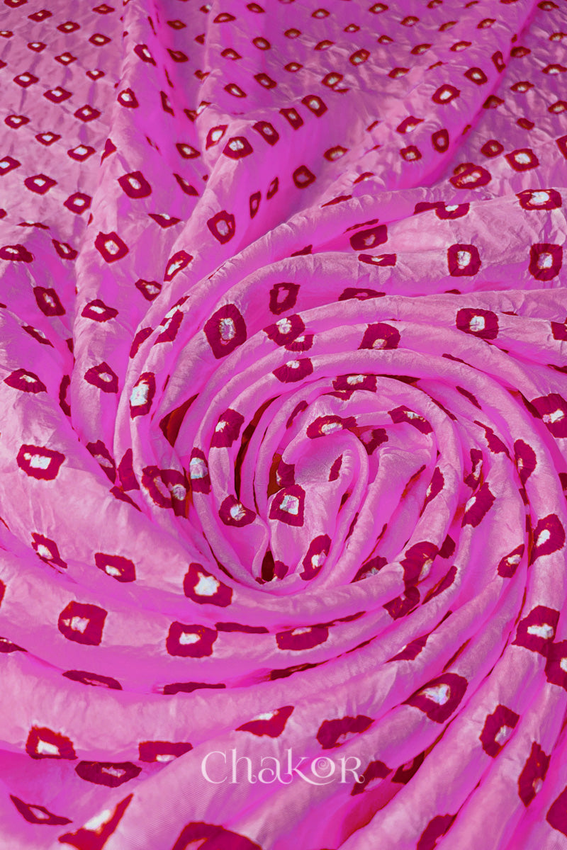 Light Pink Mulberry silk fabric with dual colour Pink bandhani dots, arranged in a swirling design  & Chakor brand watermark.
