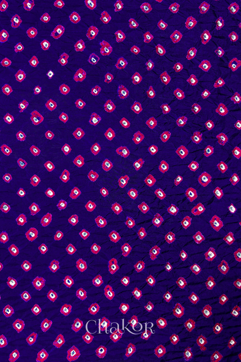 Purple Mulberry silk fabric showcasing dual colour Pink bandhani patterns and Chakor brand watermark.
