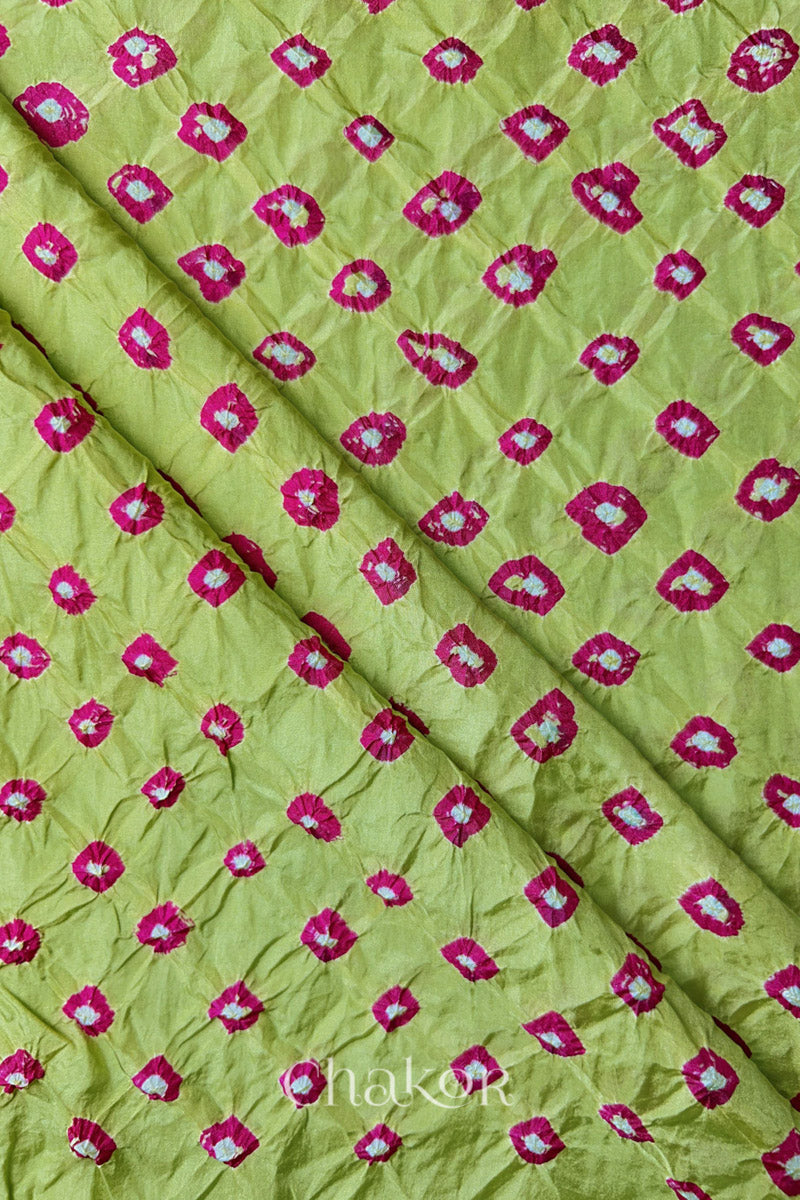 Pista Green Mulberry silk fabric showcasing dual colour Pink bandhani patterns with folds and Chakor brand watermark.
