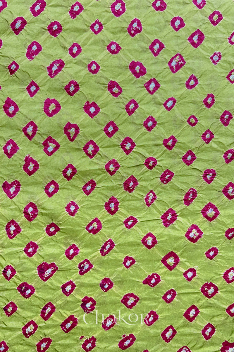 Pista Green Mulberry silk fabric showcasing dual colour Pink bandhani patterns and Chakor brand watermark.
