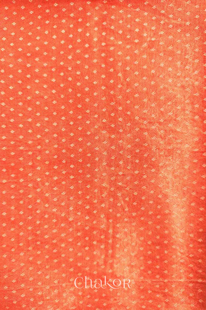 Close up of Handcrafted Peach Mashru Blouse Fabric with self woven design and silky texture.