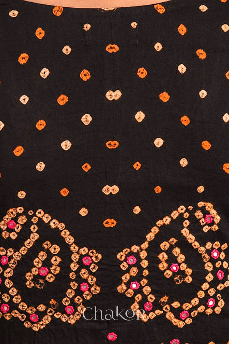 A woman wearing a traditional Black Bandhani Cotton Blouse with intricate mirror embroidered Keri - Paisley motifs and boria fabric buttons.