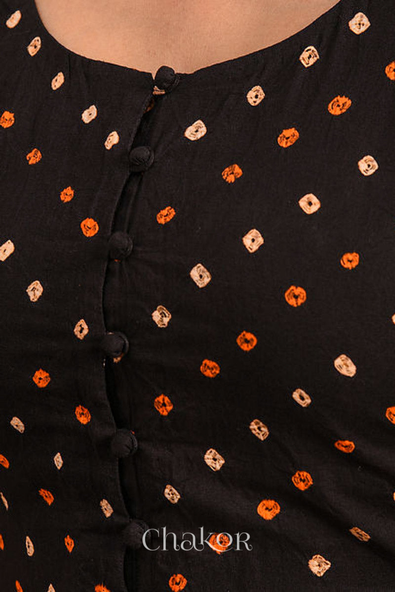 A woman wearing a traditional Black Bandhani Cotton Blouse with intricate mirror embroidered Keri - Paisley motifs and boria fabric buttons.