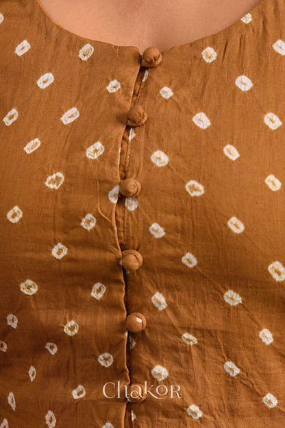 A woman wearing a traditional Mustard Yellow Bandhani Cotton Blouse with intricate mirror embroidered Keri - Paisley motifs and boria fabric buttons.